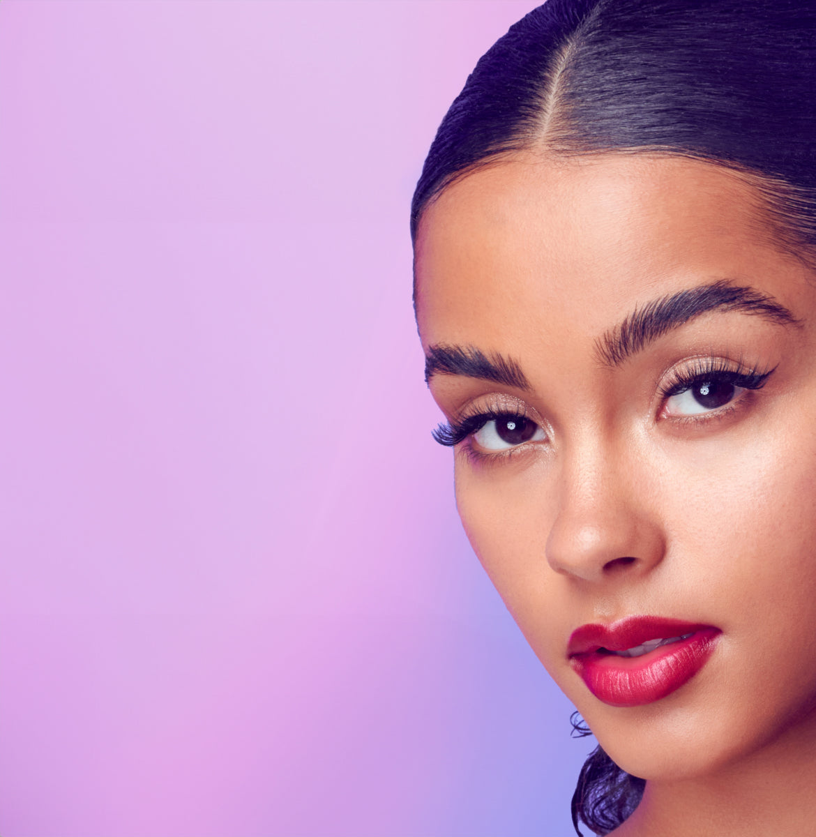 A woman modeling, long, voluminous lashes from Falscara Studio collection.