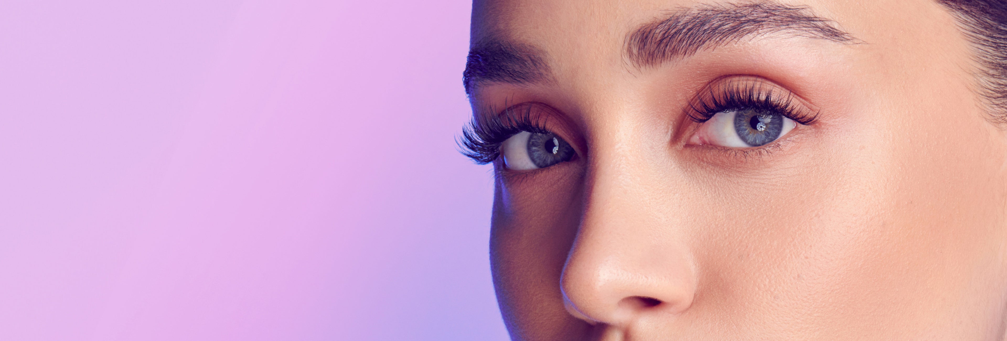 Close up of a woman modeling full, curly lashes from Falscara Studio collection lashes.