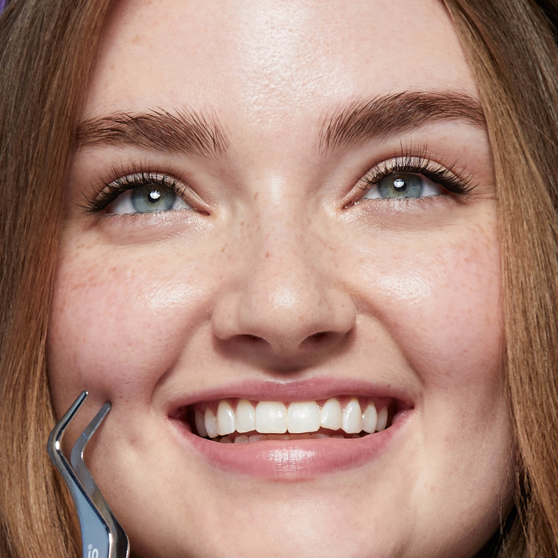 Close-up of a woman with a beautiful, professional looking lash extension using the &