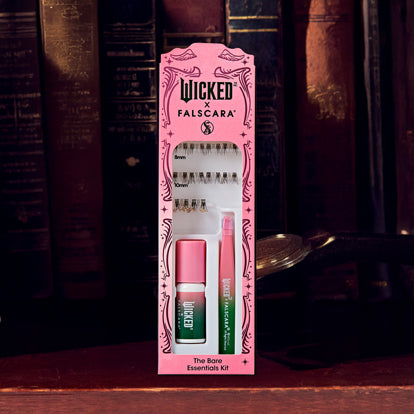 Wicked Falscara beauty essentials kit with mascara, nail polish, and false lashes on pink packaging.