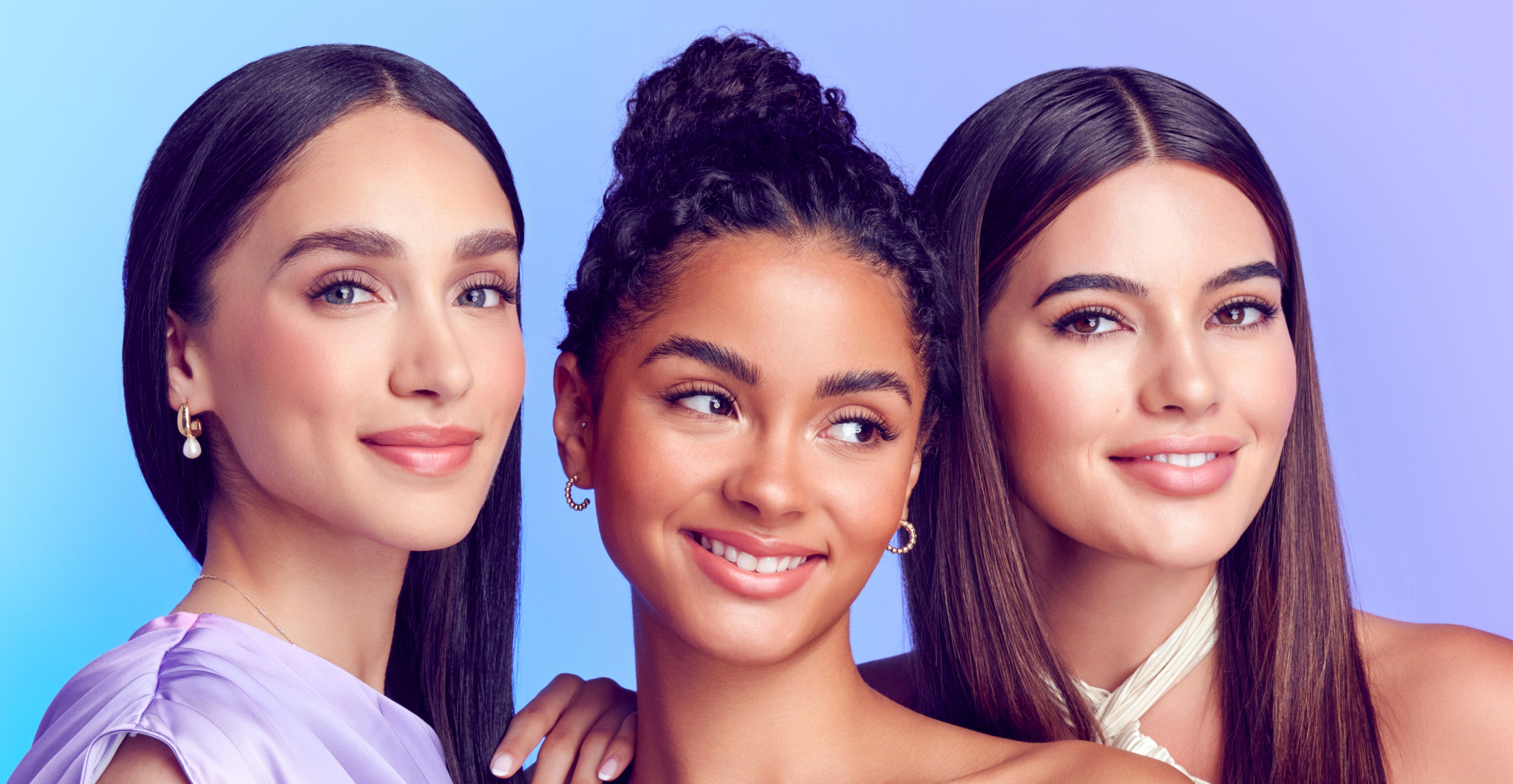 Three women modeling together with different outfits and hairstyles, showing off Falscara press on lashes. All lashes give the women a lifted eye effect with voluminous lashes. 