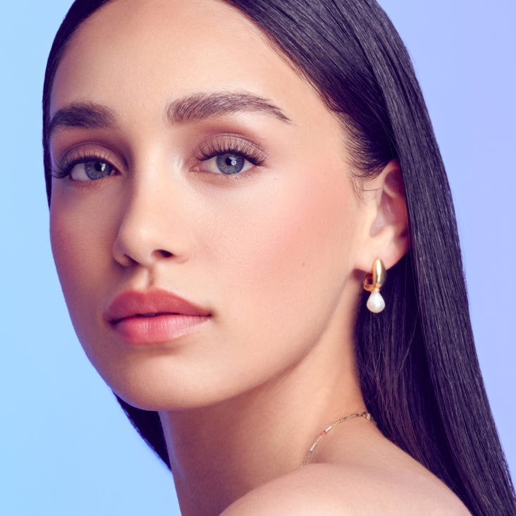 A woman modeling Falscara Studio Palette lashes in "Delicate Light". Lashes add some fullness and volume to  lashes with a natural lash look. 