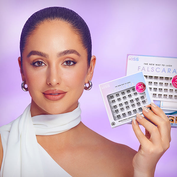 Brand Ambassador and celebrity makeup artist, Ash K Holm showing off a multipack of Falscara lash wisps and a Falscara Starter Pack. 