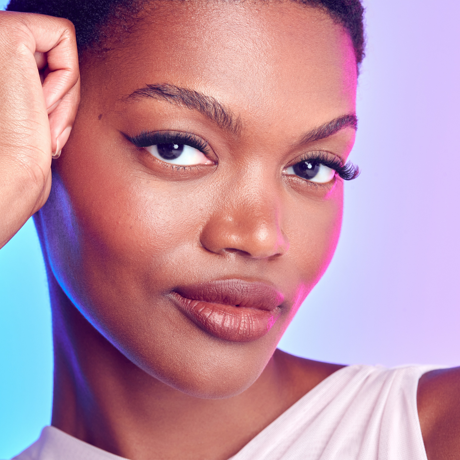 Close-up of a woman with a soft smile against a gradient background